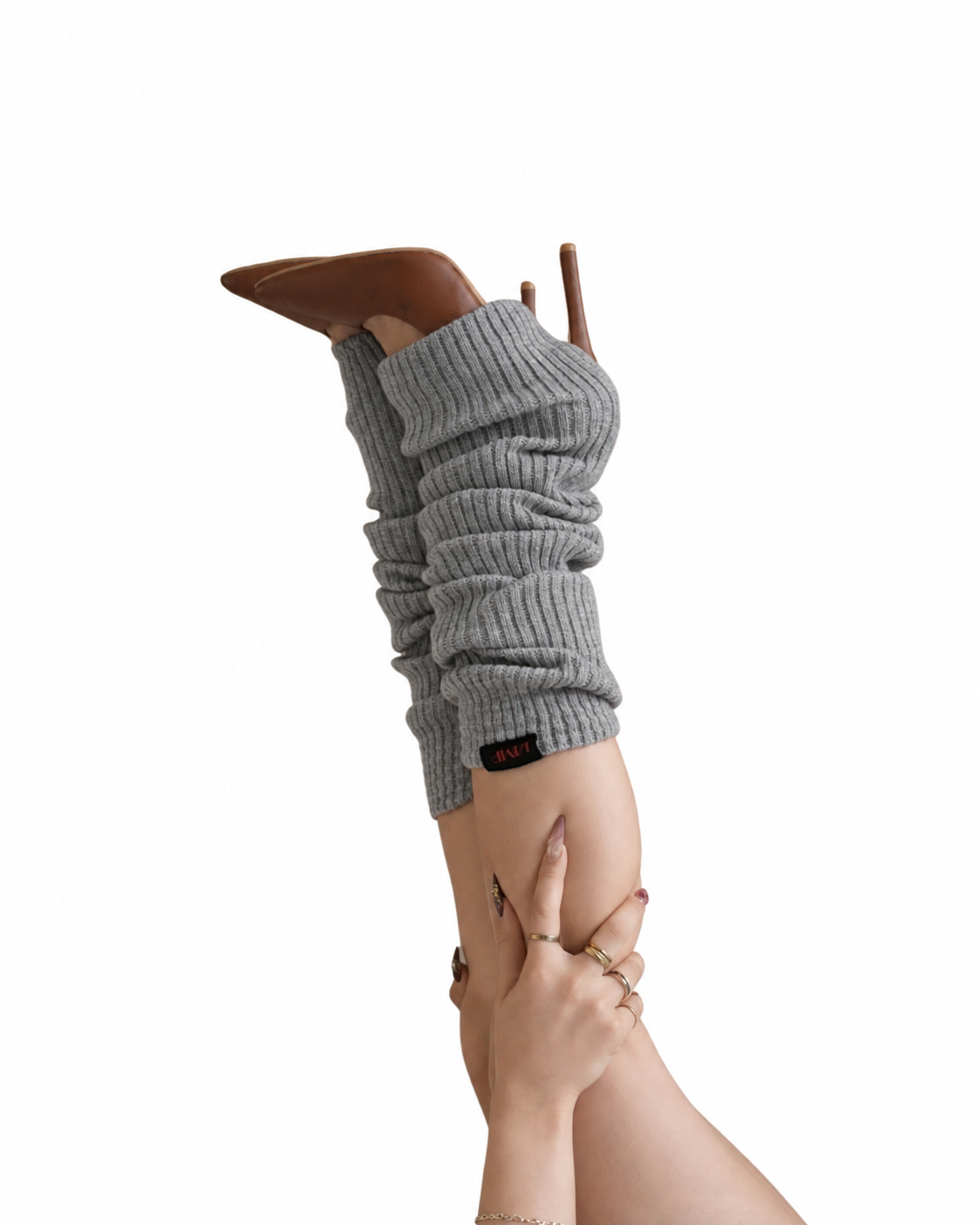 A person's leg and foot wearing a gray ribbed knit bootie cover with a brown pointed-toe stiletto boot inserted, shown against a plain white background.
